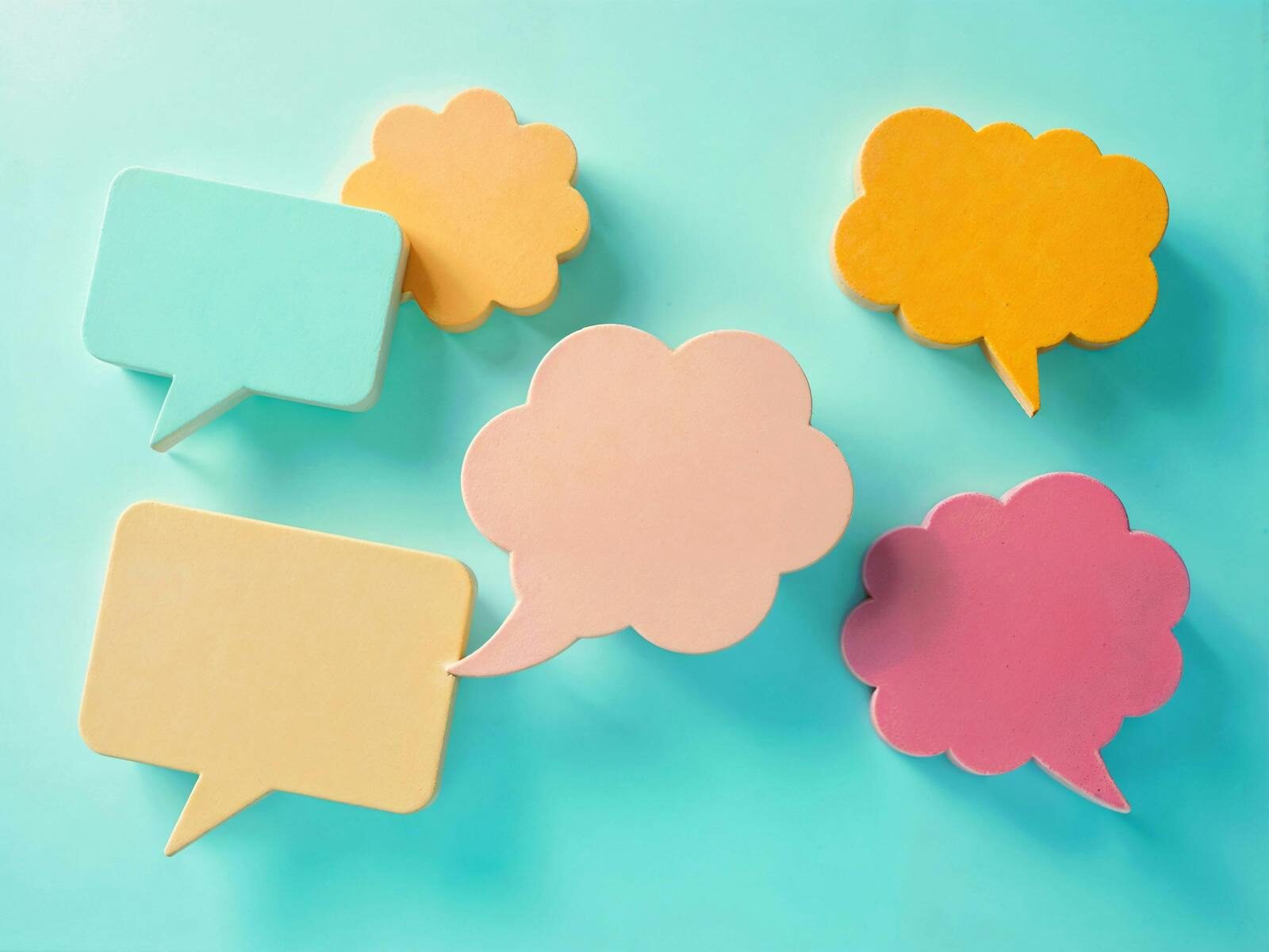 Photo by Hamza Samad Bright pastel speech bubbles on a blue background, ideal for communication themes.